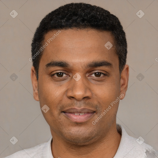 Joyful black young-adult male with short  black hair and brown eyes