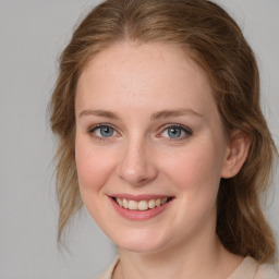 Joyful white young-adult female with medium  brown hair and blue eyes