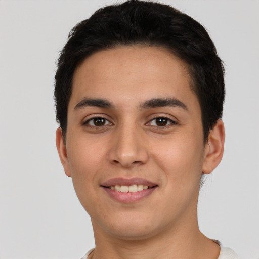 Joyful white young-adult male with short  black hair and brown eyes