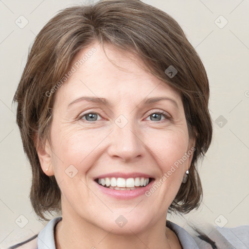 Joyful white adult female with medium  brown hair and grey eyes