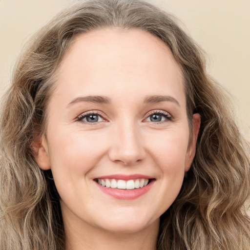 Joyful white young-adult female with long  brown hair and green eyes