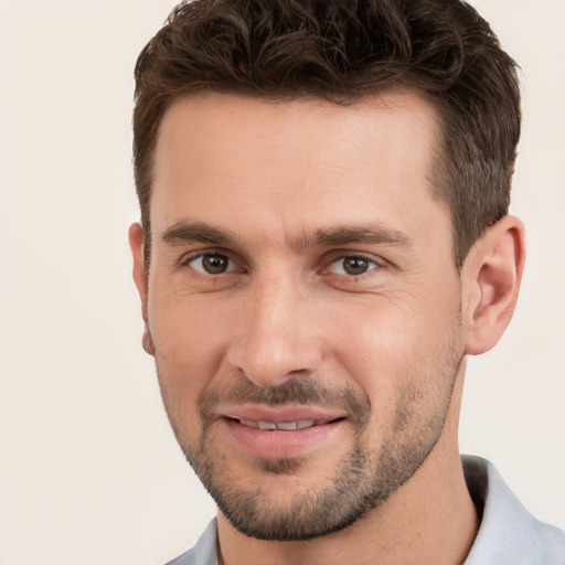 Joyful white young-adult male with short  brown hair and brown eyes