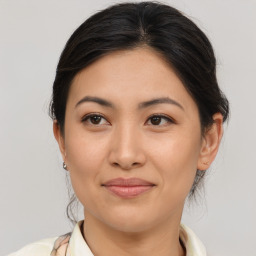 Joyful asian young-adult female with medium  brown hair and brown eyes