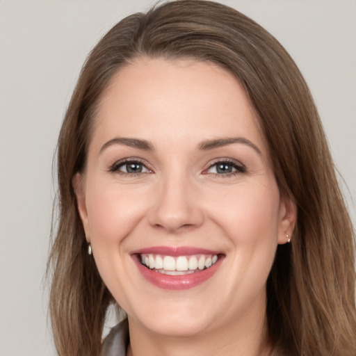 Joyful white young-adult female with long  brown hair and grey eyes