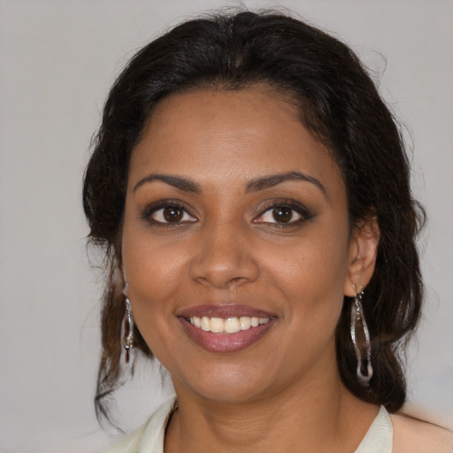 Joyful black young-adult female with medium  brown hair and brown eyes