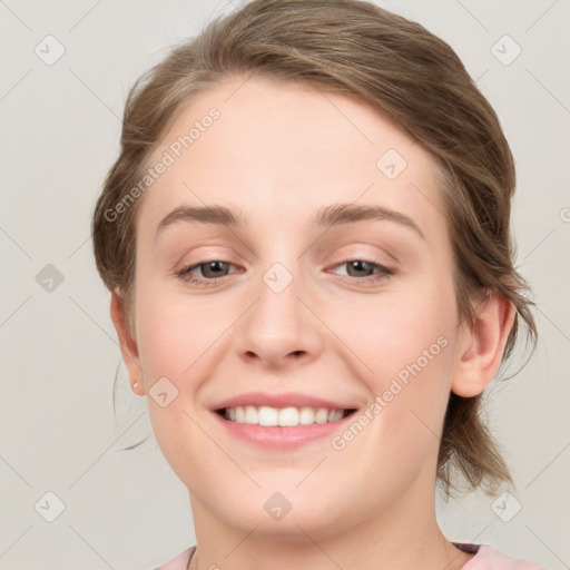 Joyful white young-adult female with medium  brown hair and blue eyes