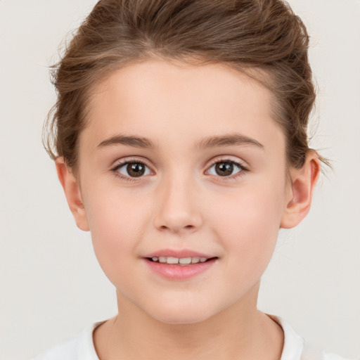 Joyful white child female with short  brown hair and brown eyes