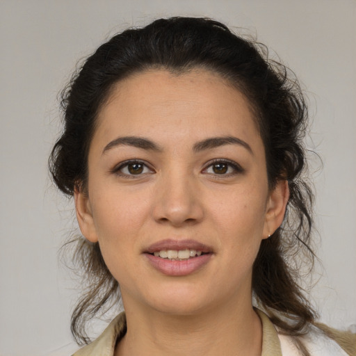 Joyful latino young-adult female with medium  brown hair and brown eyes