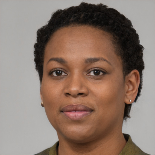 Joyful black young-adult female with short  brown hair and brown eyes