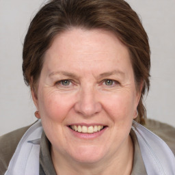 Joyful white adult female with medium  brown hair and blue eyes