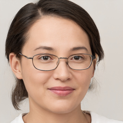 Joyful white young-adult female with medium  brown hair and brown eyes