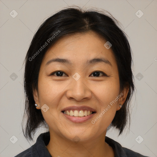 Joyful asian young-adult female with medium  black hair and brown eyes