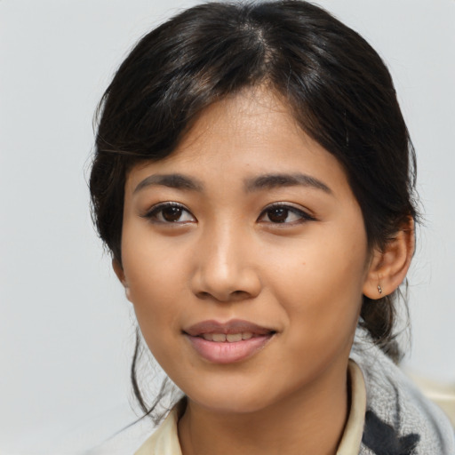 Joyful asian young-adult female with medium  black hair and brown eyes