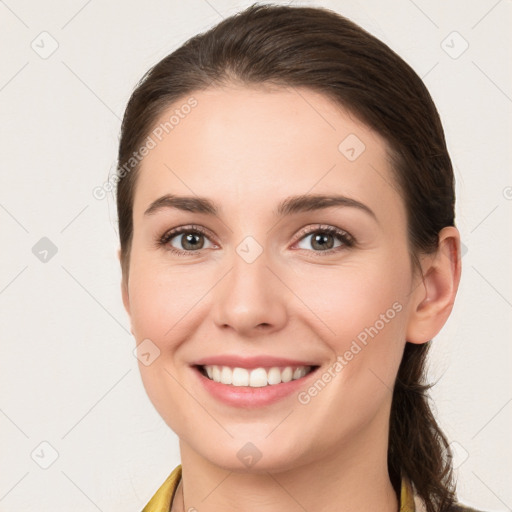 Joyful white young-adult female with long  brown hair and brown eyes