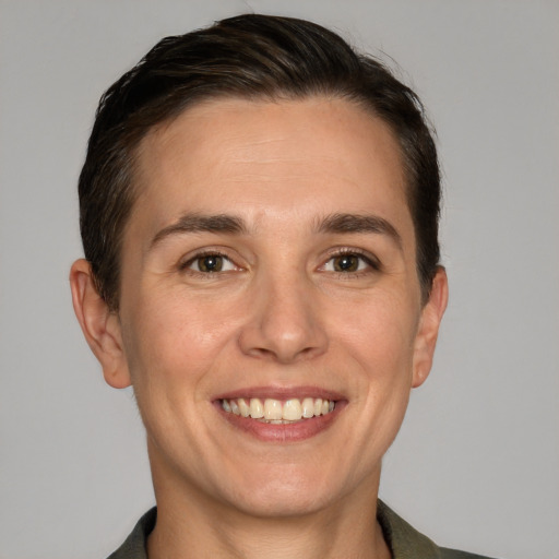 Joyful white young-adult female with short  brown hair and grey eyes