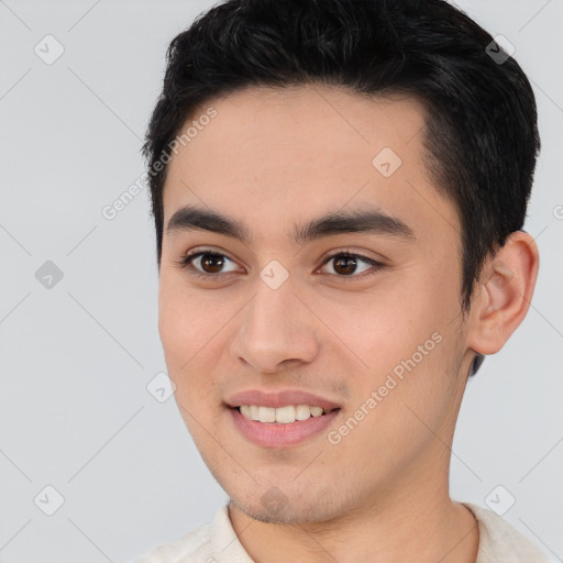 Joyful white young-adult male with short  black hair and brown eyes