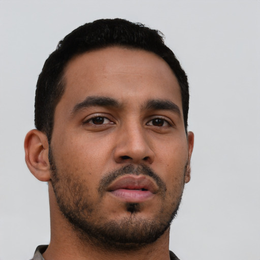 Neutral latino young-adult male with short  black hair and brown eyes