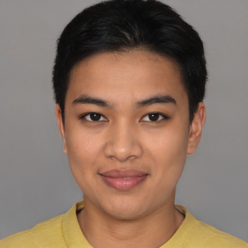 Joyful asian young-adult male with short  black hair and brown eyes