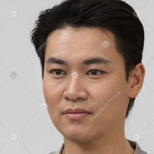 Joyful asian young-adult male with short  black hair and brown eyes