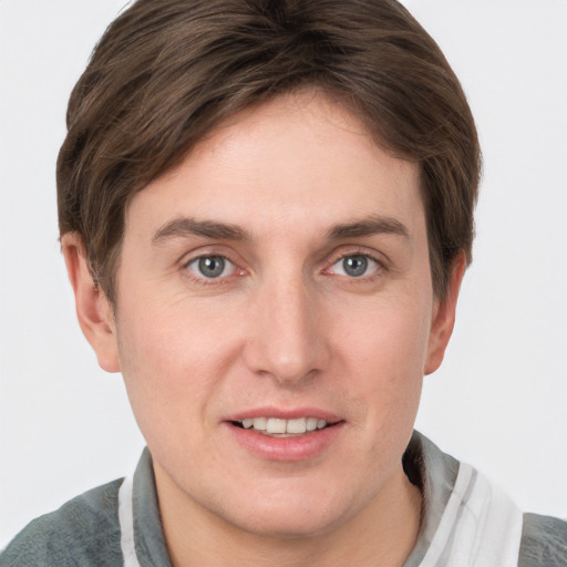 Joyful white young-adult male with short  brown hair and grey eyes