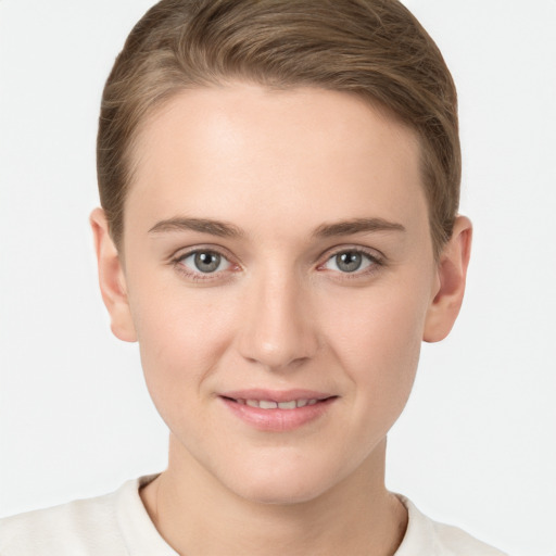 Joyful white young-adult female with short  brown hair and grey eyes