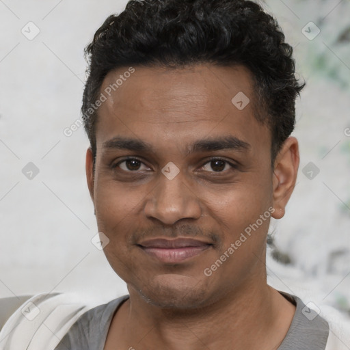 Joyful black young-adult male with short  black hair and brown eyes