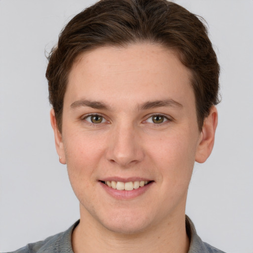 Joyful white young-adult female with short  brown hair and grey eyes