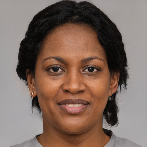 Joyful black young-adult female with medium  black hair and brown eyes
