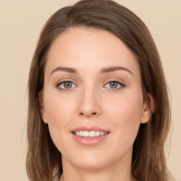 Joyful white young-adult female with long  brown hair and green eyes