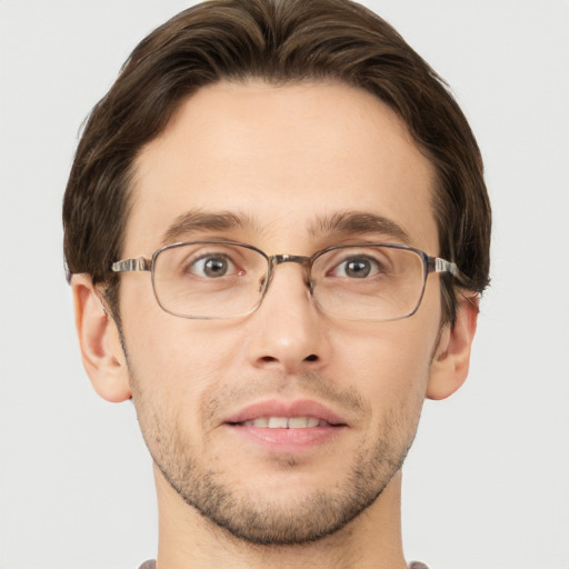 Joyful white young-adult male with short  brown hair and grey eyes