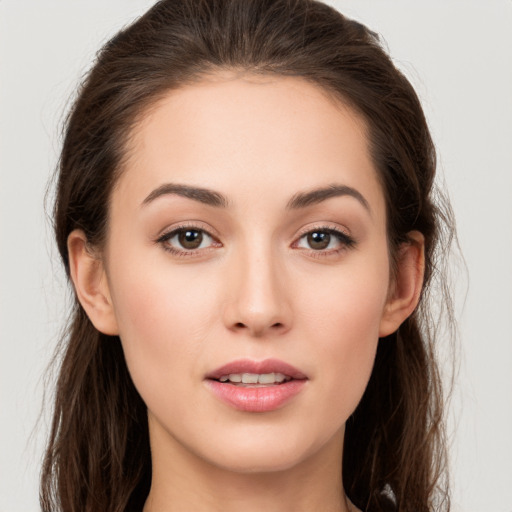 Joyful white young-adult female with long  brown hair and brown eyes