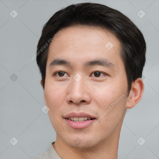 Joyful asian young-adult male with short  brown hair and brown eyes