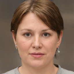 Joyful white adult female with medium  brown hair and brown eyes