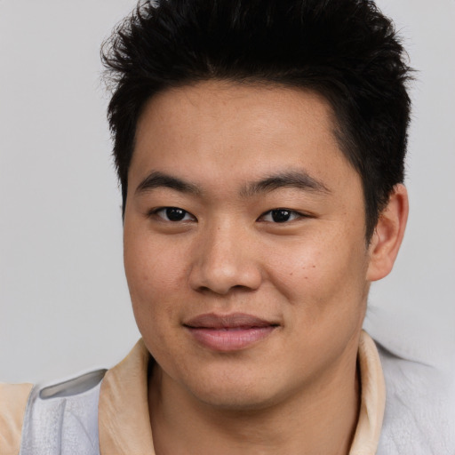 Joyful asian young-adult male with short  brown hair and brown eyes