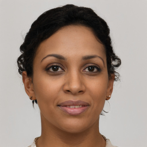 Joyful latino young-adult female with short  brown hair and brown eyes