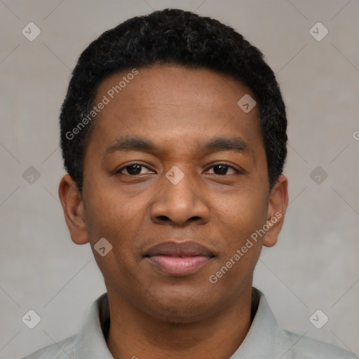 Joyful black young-adult male with short  black hair and brown eyes