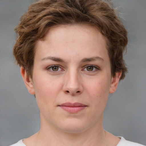 Joyful white young-adult female with short  brown hair and green eyes