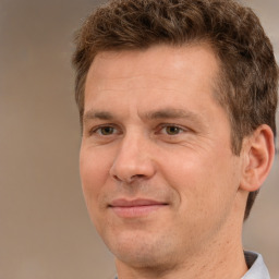 Joyful white adult male with short  brown hair and brown eyes