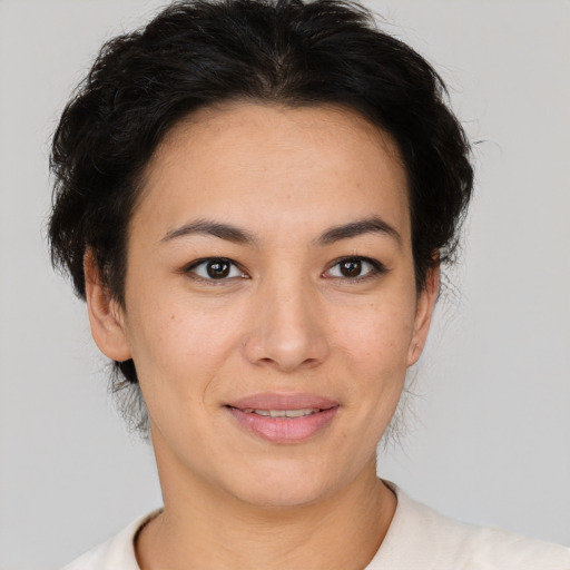 Joyful latino young-adult female with short  brown hair and brown eyes