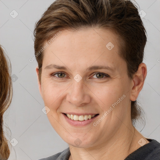 Joyful white adult female with medium  brown hair and brown eyes