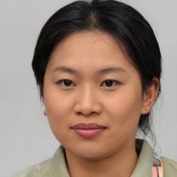 Joyful asian young-adult female with medium  brown hair and brown eyes