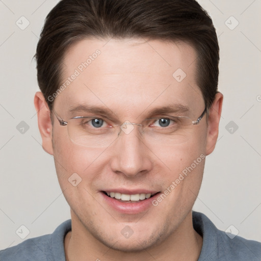 Joyful white young-adult male with short  brown hair and grey eyes