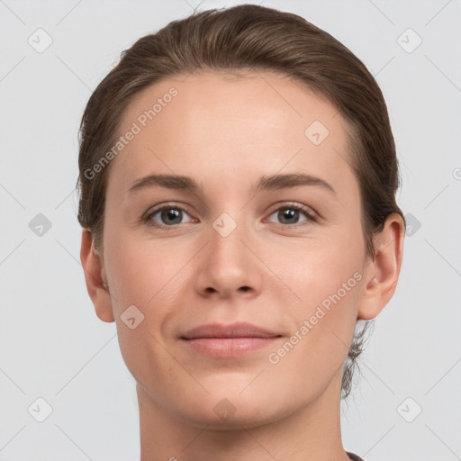 Joyful white young-adult female with short  brown hair and grey eyes