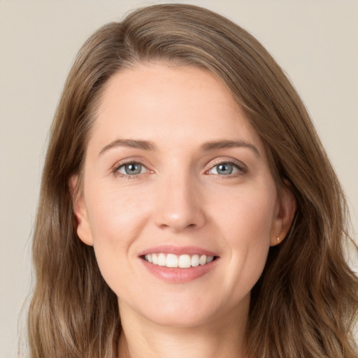 Joyful white young-adult female with long  brown hair and grey eyes