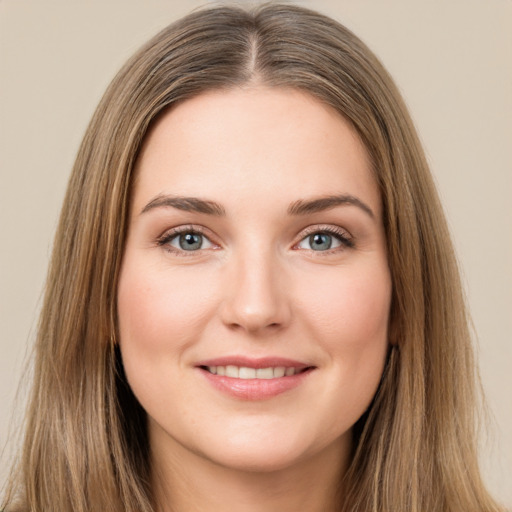 Joyful white young-adult female with long  brown hair and green eyes