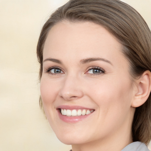 Joyful white young-adult female with medium  brown hair and green eyes