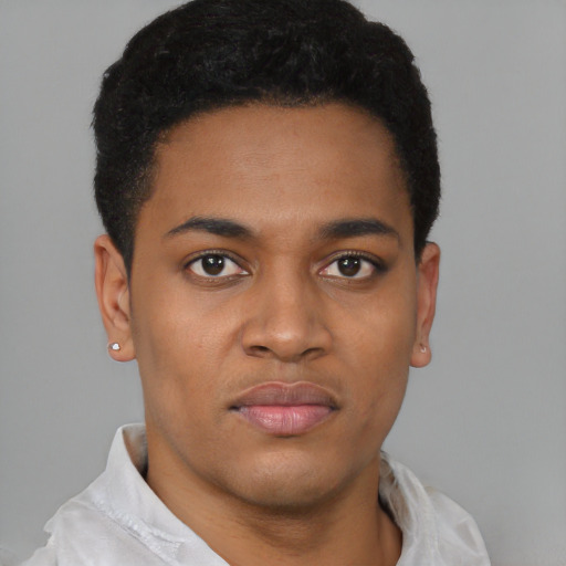 Joyful black young-adult male with short  brown hair and brown eyes
