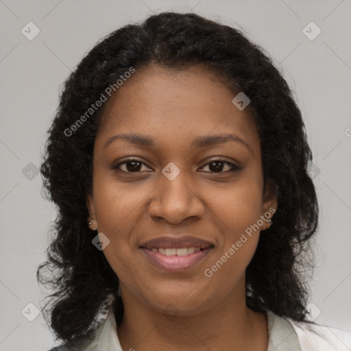 Joyful black young-adult female with long  brown hair and brown eyes