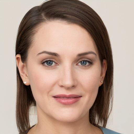 Joyful white young-adult female with medium  brown hair and grey eyes