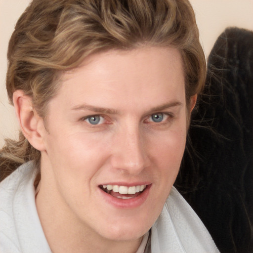 Joyful white young-adult female with medium  brown hair and blue eyes